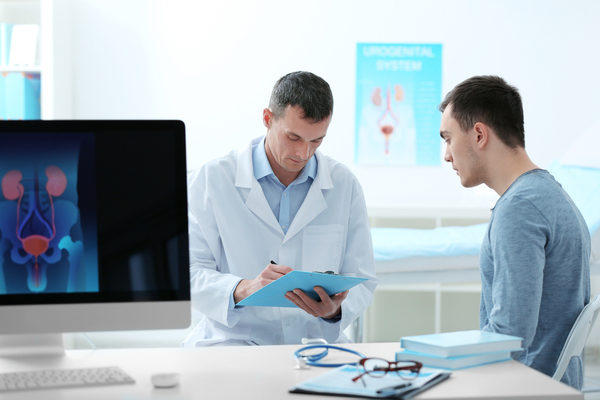 man talking to a urologist during exam about his symptoms